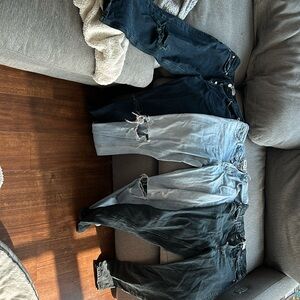 Three agolde straight cut high waisted jeans.